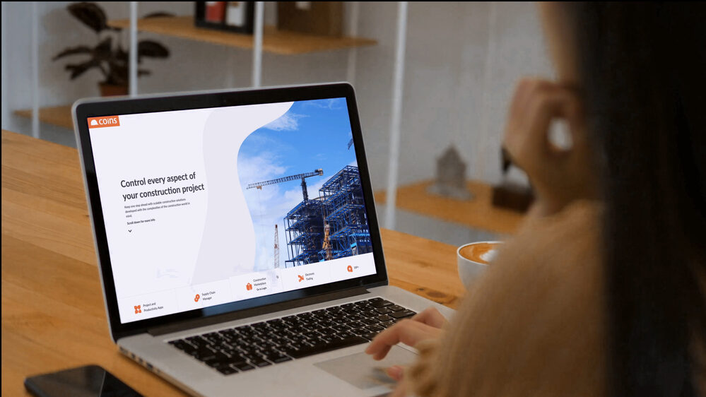 COINS construction software displayed on laptop screen.